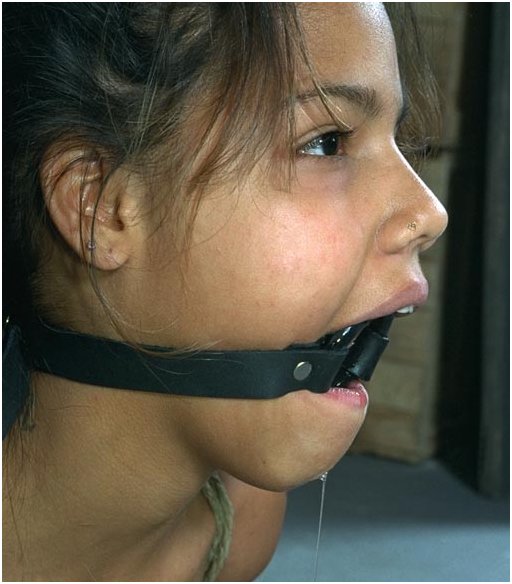 woman drools from a leather-wrapped ring gag