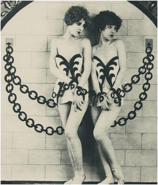 art magazine photo of nude sisters enhanced in the darkroom to appear bound in chains